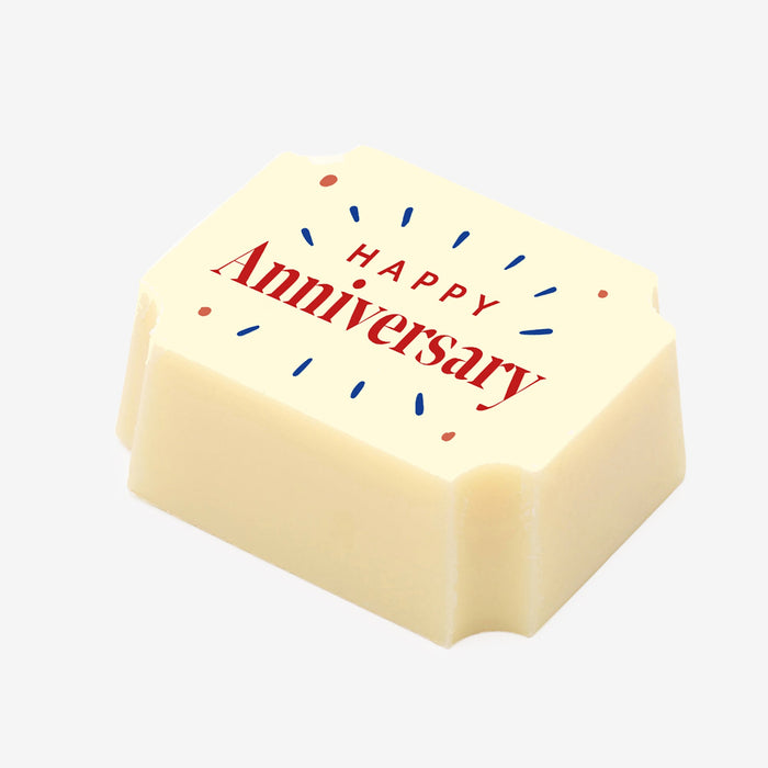 A white chocolate filled with dark chocolate ganache, made by Harry Specters, with a Happy Anniversary message printed on the top.