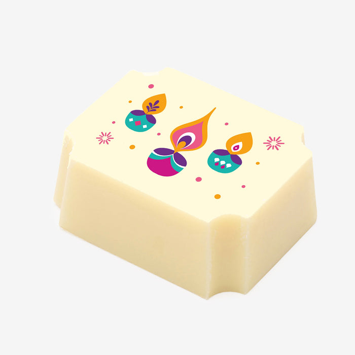 A white chocolate filled with dark chocolate ganache, made by Harry Specters, with a Diwali themed image printed on the top.