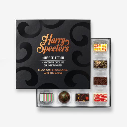 A chocolate selection box containing 16 chocolates, partially covered by a lid showing the name Harry Specters. The chocolates seen within this gift box are a colourful mix of white, milk, and dark chocolate with two New Baby message chocolates.