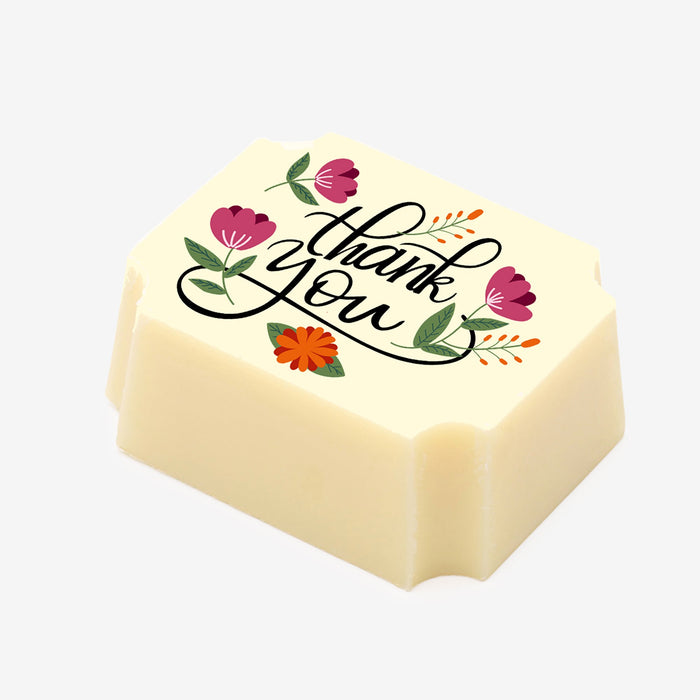 A white chocolate filled with dark chocolate ganache, made by Harry Specters, with a Thank You message printed on the top.