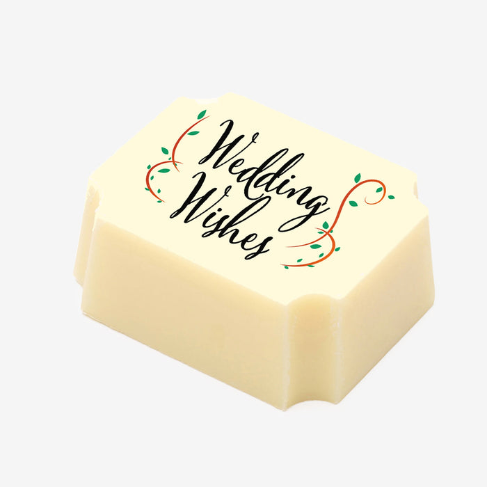 A white chocolate filled with dark chocolate ganache, made by Harry Specters, with a Wedding Wishes message printed on the top.